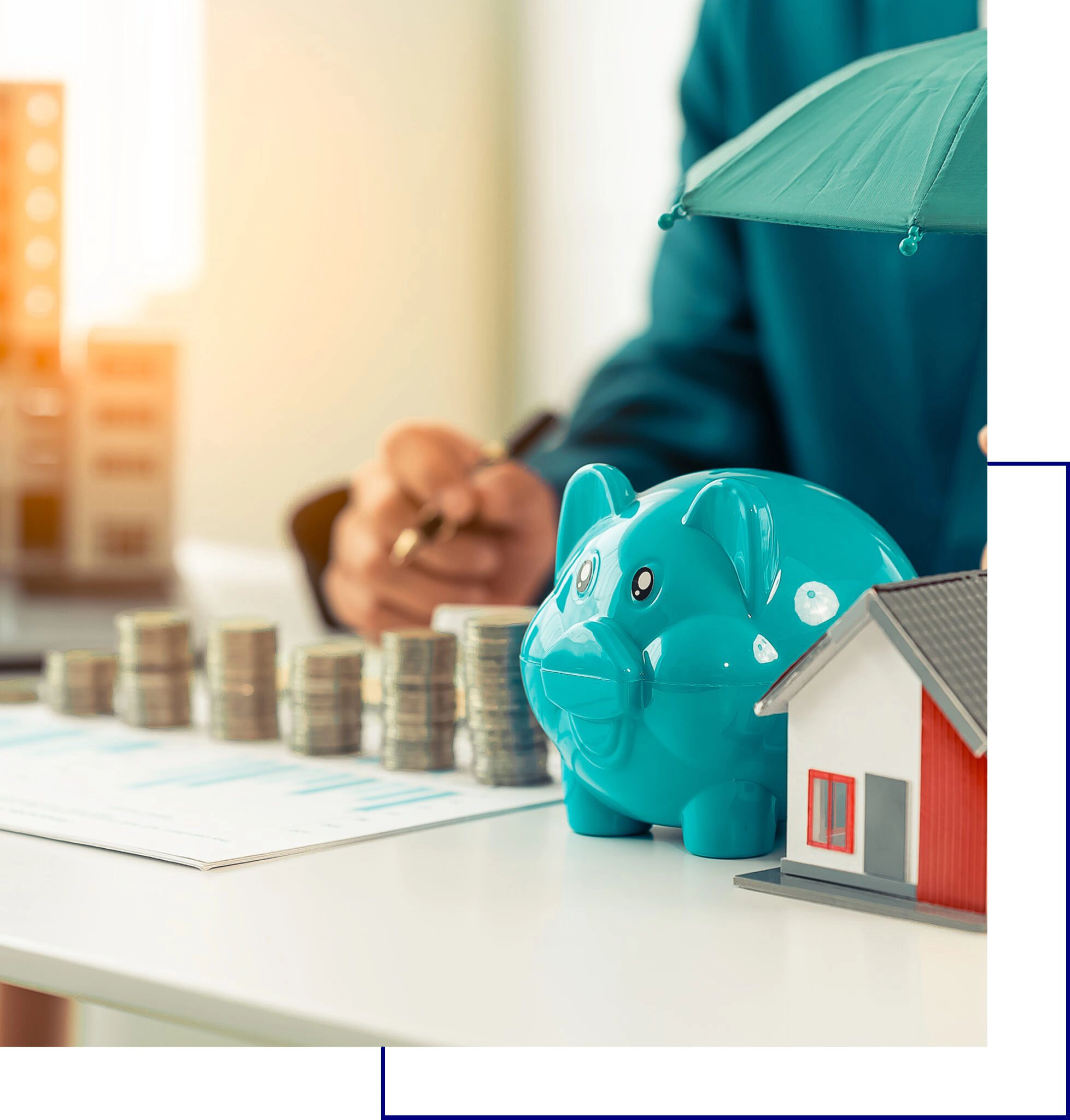 Piggy bank with coins and a small house model symbolizing savings.