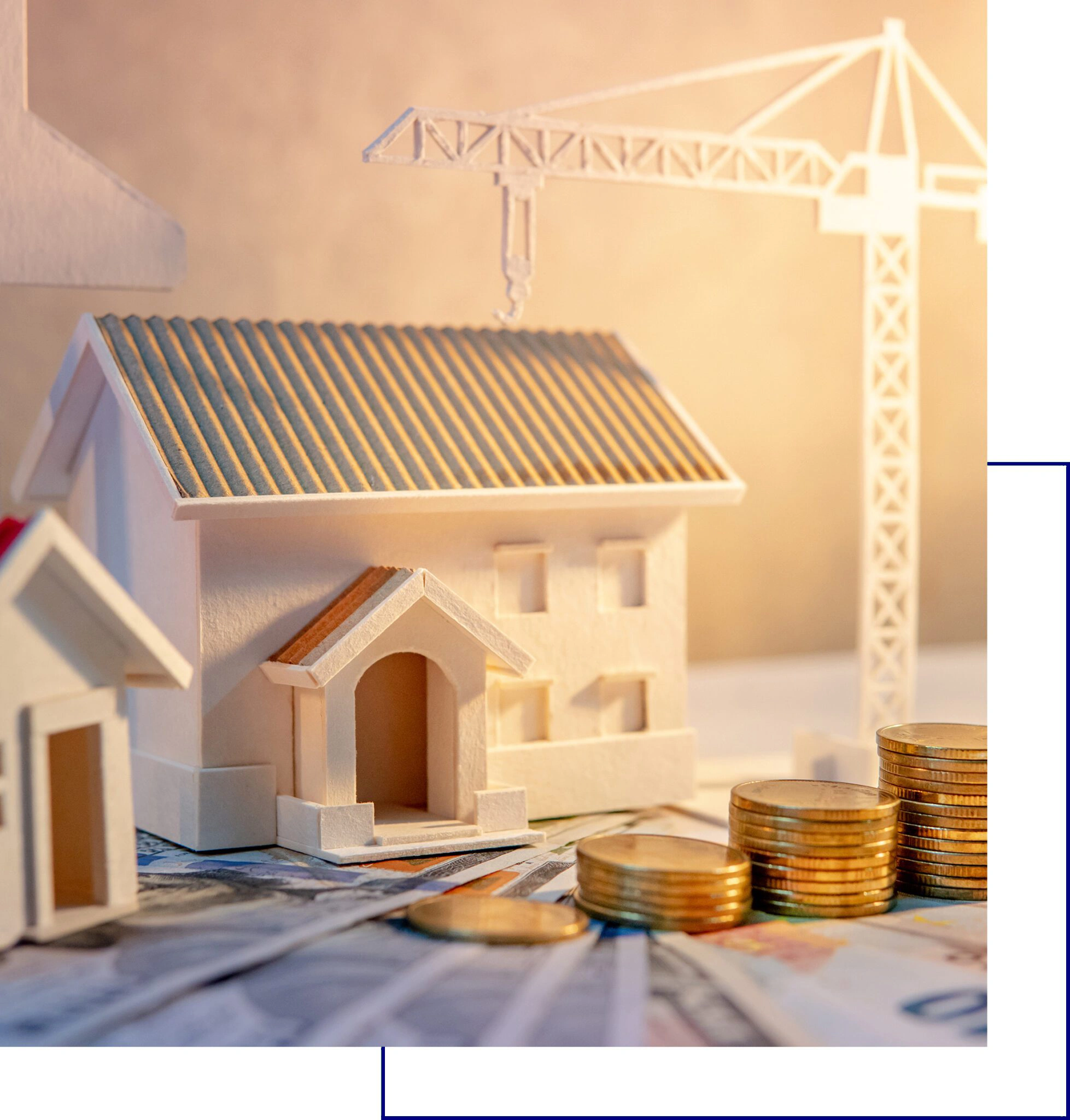 Model houses and stacked coins symbolizing real estate investment and construction.